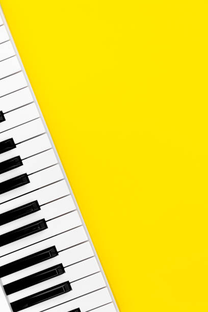 istock Piano keys on a yellow background, top view, flat lay. 1475328028