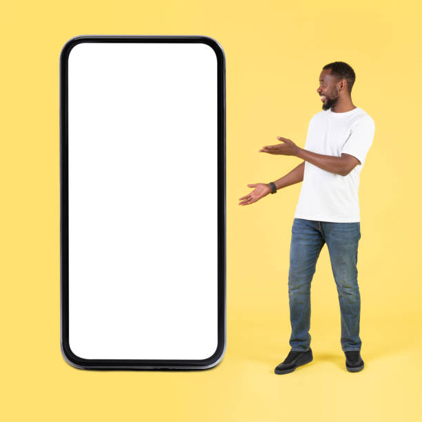istock African Man Showing Big Cellphone With Empty Screen, Yellow Background 1475329078