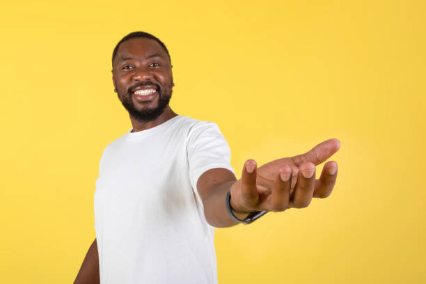 istock Happy Black Man Showing Invisible Object Standing Over Yellow Background 1475329756