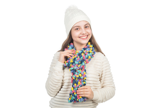 Her perfect style. childhood happiness. small kid wear knitted scarf isolated on white. child in hat and sweater. autumn fashion style. warm clothes. happy teen girl in winter clothes.