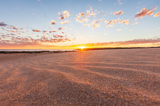 Remote arid desert sand dunes by the coast at sunset. Photographed in South Australia.