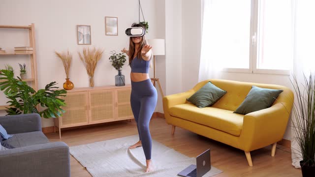 Woman in VR headset practicing yoga