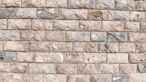 Wall of large square stones of gray color. High quality photo
