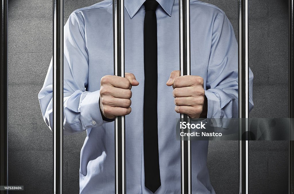Man in jail Young corrupted businessman behind the prison bars Prison Stock Photo