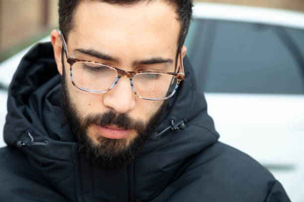 Young man in the street using eyeglasses