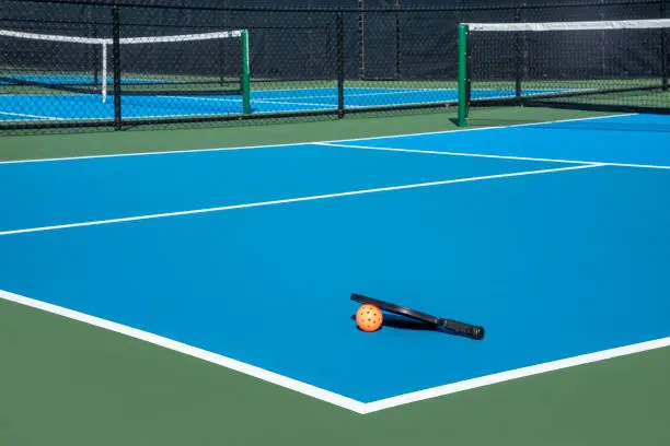 Photo of Pickleball Court with Paddle and Ball