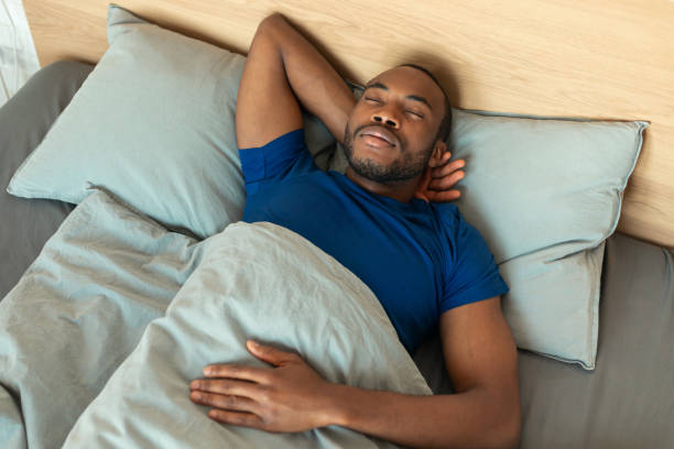 istock High Angle Shot Of Sleeping Black Man Napping In Bedroom 1475341945