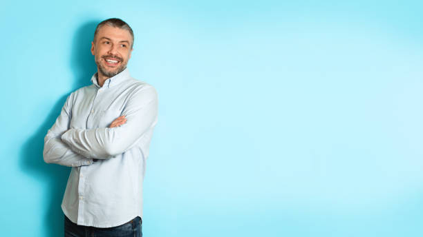 istock Middle Aged Man Posing Looking Aside Over Blue Background, Panorama 1475342050