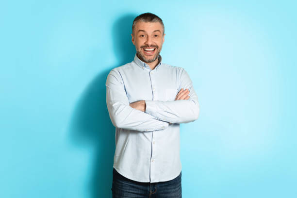 istock Positive Middle Aged Man Posing Crossing Hands Over Blue Background 1475342056