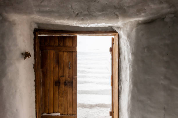 Wooden hut in orange color and white door. Snafelness, Iceland