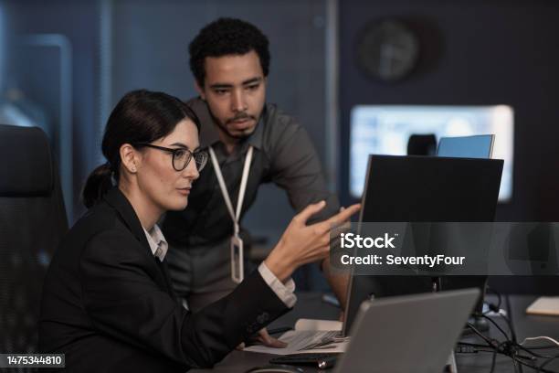 Senior Project Manager Pointing At Computer Screen While Reviewing Code Stock Photo - Download Image Now