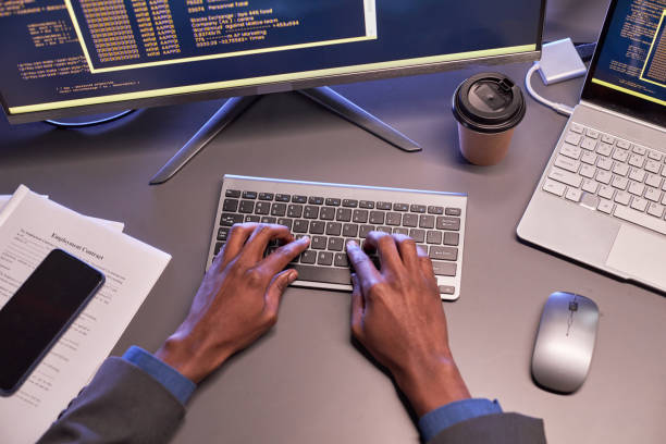 istock Top view of male hands typing at computer keyboard at workplace in IT office 1475344835
