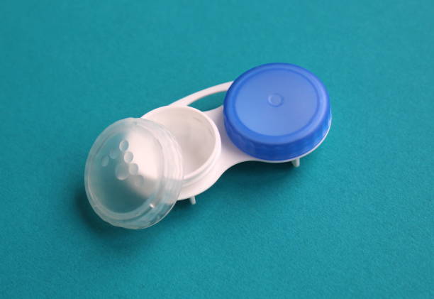istock Container for lenses lie on a turquoise background. 1475345811