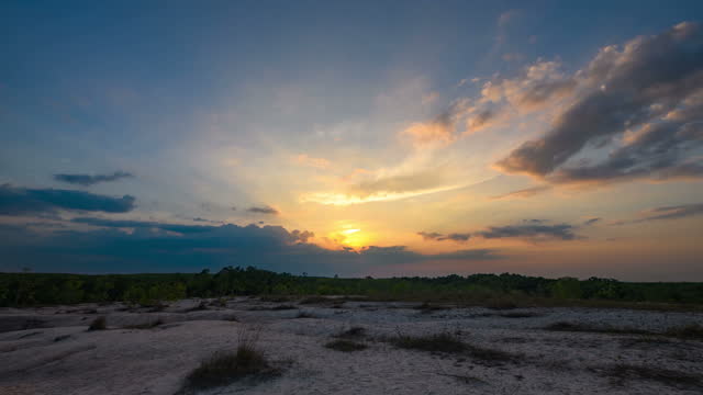 TL: Sunset over scenic point with forest and sand dune in Nasan District, Surat Thani Province, Thailand
