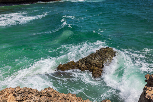 Rocky coast washed by Atlantic Ocean waves. Aruba.