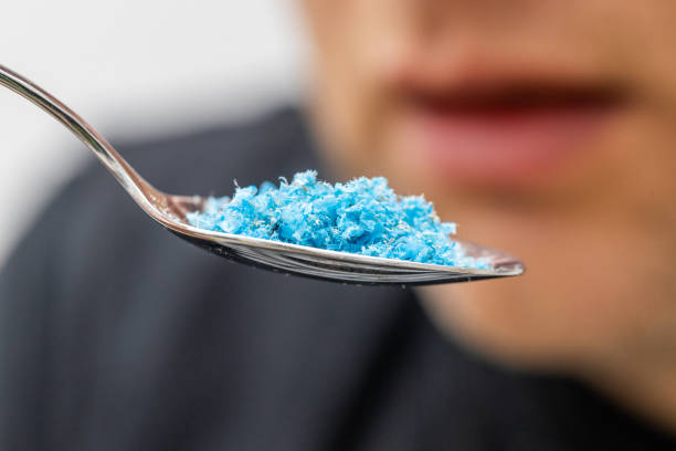 istock Microplastic in food, Environment and health concept, Person putting a spoon with plastic particles in his mouth 1475350165