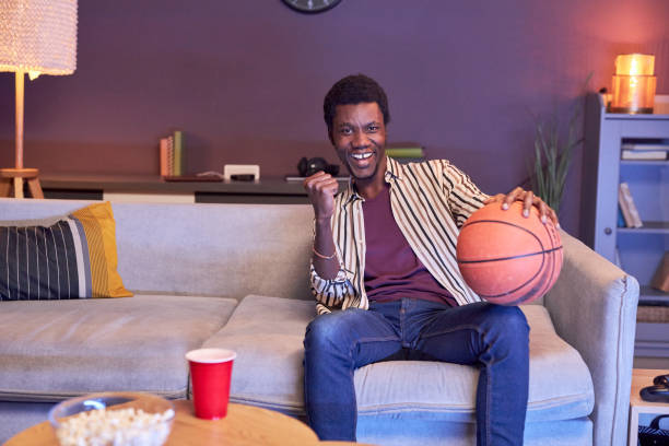 istock Black man watching basketball match on Tv 1475352327