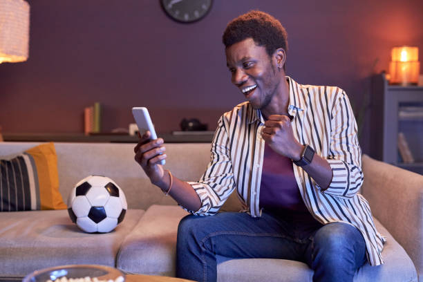 istock Excited black man using online betting app 1475352444