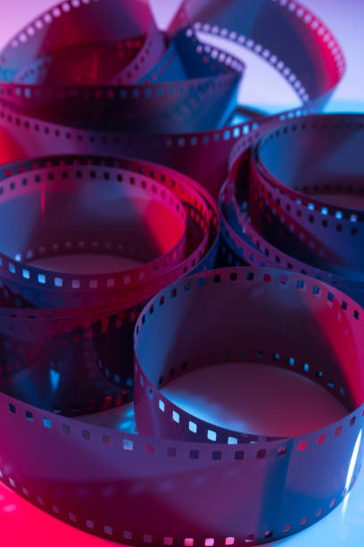 istock 35 mm film curls illuminated with red and blue colored lights. 1475352515