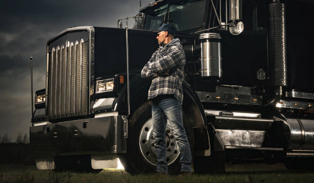 American Transportation Industry Theme with Trucker and His Semi Truck stock photo