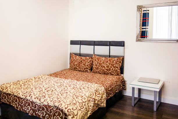 istock modern cozy bedroom interior with bed, bedside table and mirror. Rest 1475353935