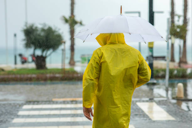 istock Man holding umbrella on a rainy day 1475354463