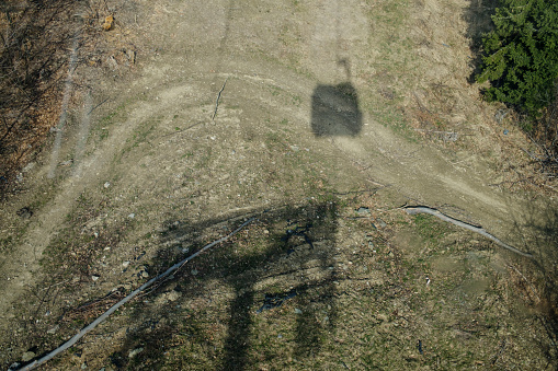 shadow of the cable car cabin on the surface, sunny day, early spring