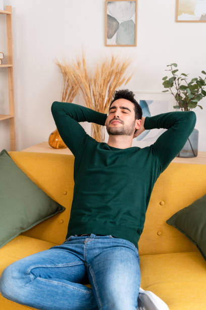 istock Thoughtful man relaxing on sofa in living room at home 1475357053