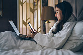 Woman working with laptop at a hotel room