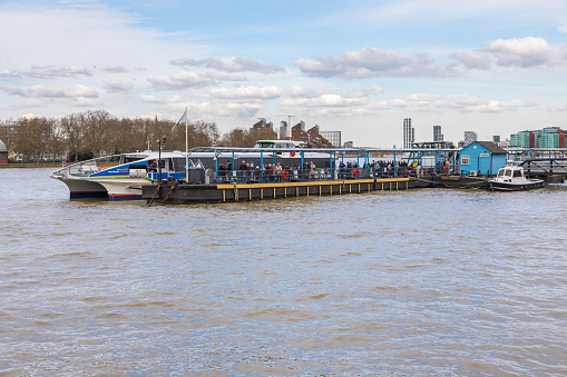 Woolwich, London - 15 May 2023: UberBoat by Thames Clipper speeding towards Woolwich Ferry terminal on Thames