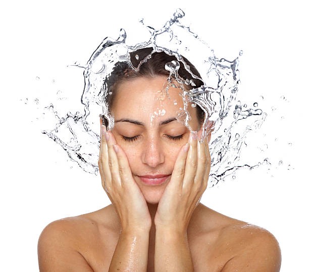 Wet woman face with water drops Beautiful wet woman face with water drop. Close-up portrait on white background woman washing face stock pictures, royalty-free photos & images