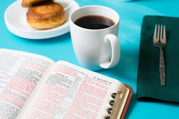Friends share coffee and a snack as they study the Bible together.  Green napkins on a turquoise table cloth.