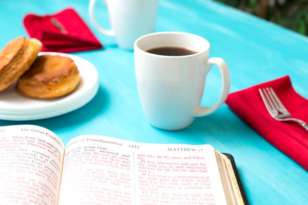 Friends share coffee and a snack as they study the Bible together.  Red napkin and turquoise tablecloth.