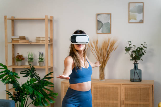 istock Woman in VR headset practicing yoga 1475363708