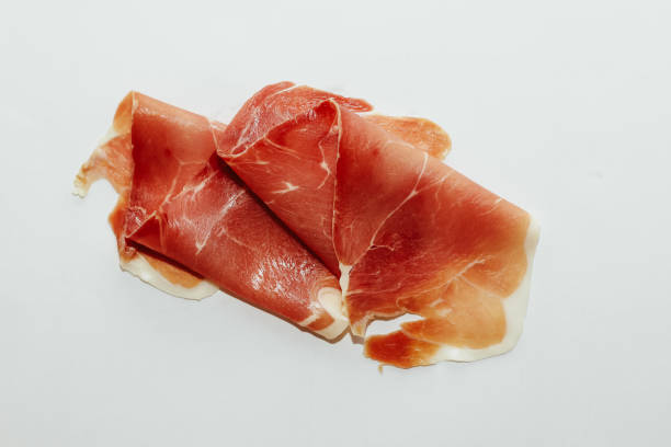 istock Pieces of dried pork jamon prosciutto on a white background 1475364159