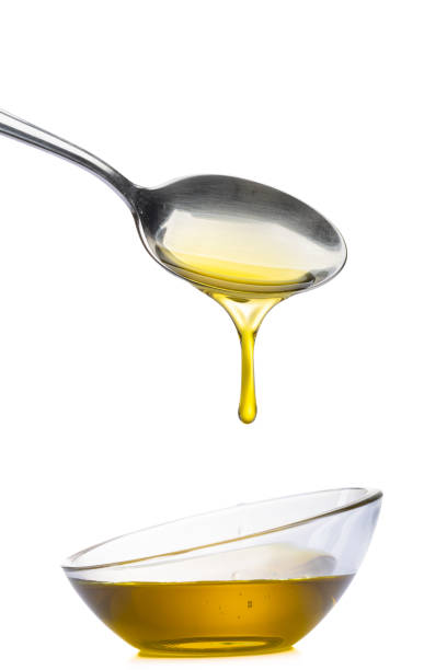 istock Organic olive oil pouring from the spoon 1475364408