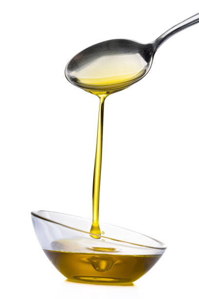 istock Organic olive oil pouring from the spoon 1475364427