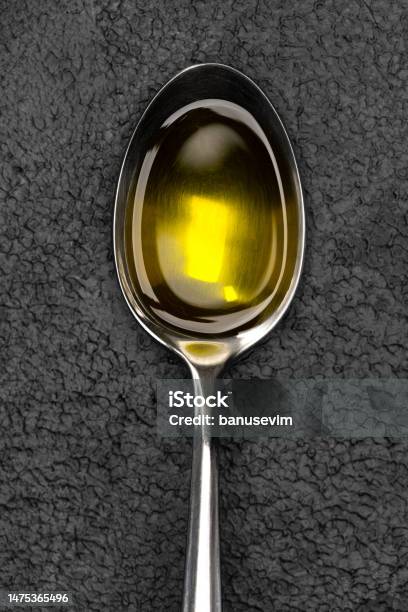 A Spoonful Of Organic Olive Oil On Vintage Background Stock Photo - Download Image Now