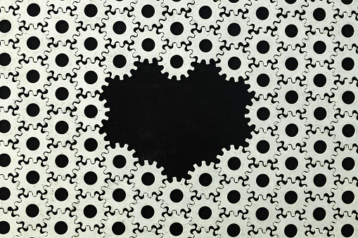 Gear background. A large number of steel gears connected to each other on a black background.