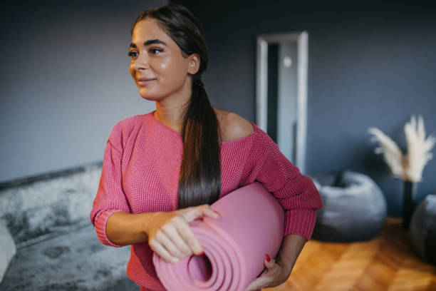 istock Young beautiful woman is preparing for home training 1475366110