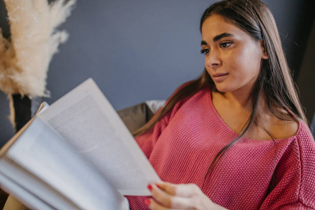 istock A young beautiful woman is reading a book 1475367768