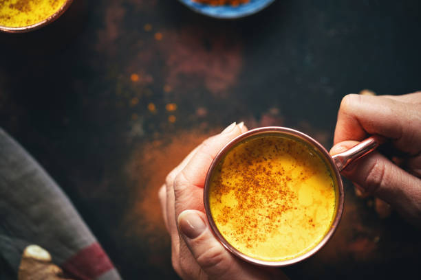 Healthy Golden Milk with Turmeric Fresh Made Golden Milk with Turmeric, Cinnamon and Ginger anti inflammatory stock pictures, royalty-free photos & images