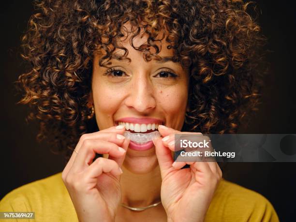 Happy Young Woman Holding Inivisible Teeth Aligners Stock Photo - Download Image Now