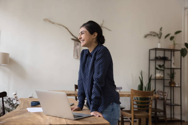 istock Cheerful Indian entrepreneur woman thinking over creative business project 1475369654