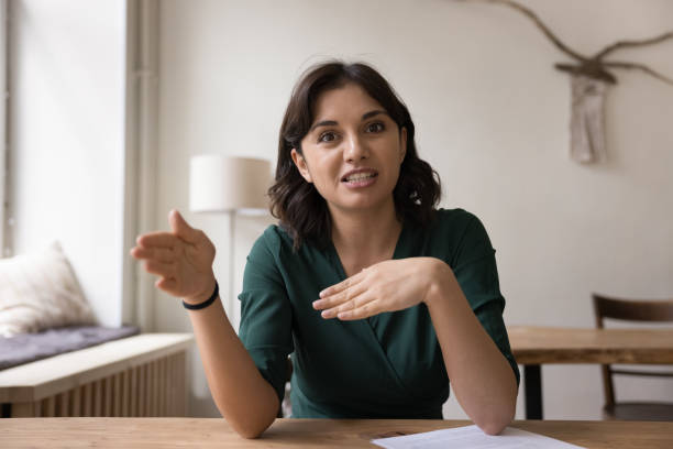 istock Positive engaged freelance professional woman speaking at camera 1475369661