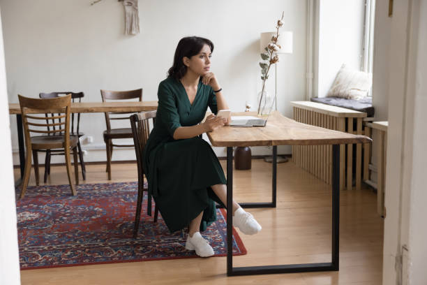 istock Thoughtful pretty freelance business woman using digital gadgets 1475369665