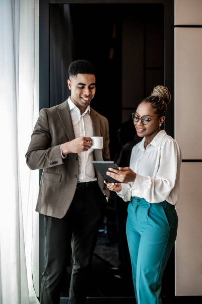 istock Casually dressed business colleagues seen talking about some results on the digital tablet 1475370898