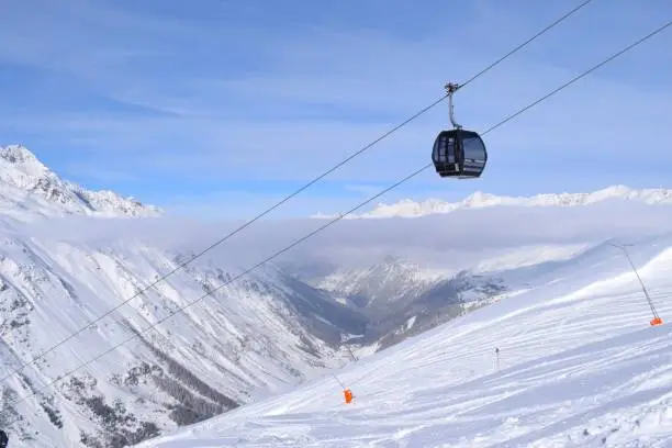 Obergurgl, Tyrol, Austria: Gondola ski lifts backdropped by a valley view of the snow capped mountains of the Ötztal Alps in Tyrol, Austria.