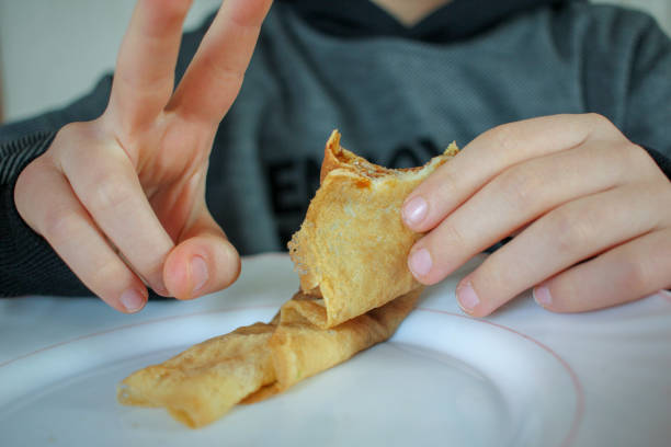 istock boy eating a crepe at home 1475377592