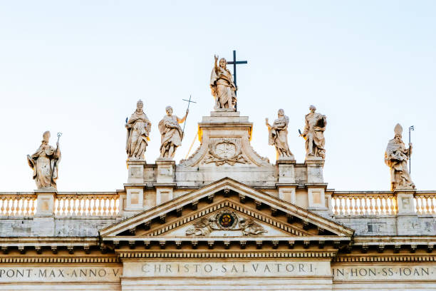 Statues of Jesus Christ and the various saints on top of the facade of Archbasilica of St. John Lateran in Rome, Italy stock photo